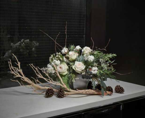 Floral Centrepiece of White Pink Roses, Cotton Flowers, White Miniature Roses, Brunia Berries, Elderberries and Assorted Greenery with a Large Dried Branch and Pine Cones
