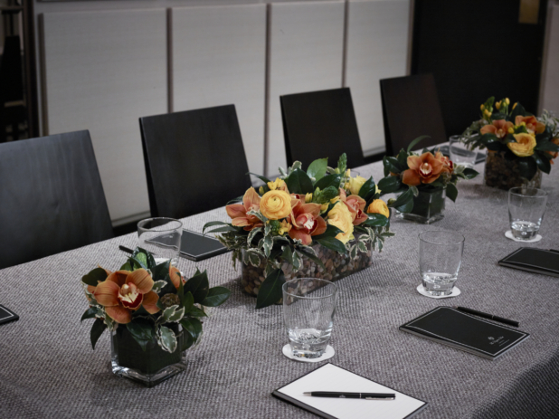 Close Up of Yellow and Orange Floral Arrangements for a Formal Business Meeting in an Indoor Setting