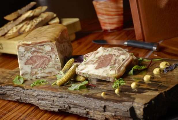 UNKNOWN terrine with cornichons and artful dollops of mustard on a rustic charcuterie board