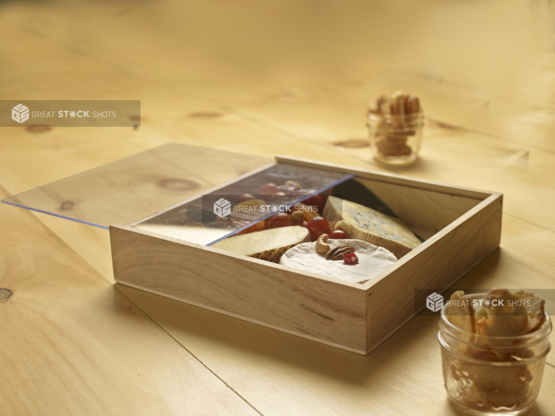 Wooden gift box with cheeses fruit and nuts