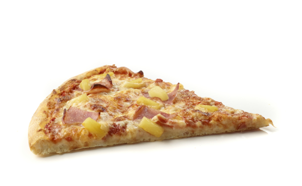 Side View of a Jumbo Hawaiian Pizza Slice with Pineapple Chunks and Sliced Ham Shot on White for Isolation