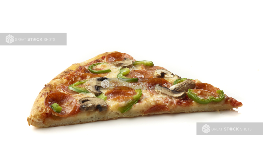 Side View of a Jumbo Deluxe Pizza Slice with Pepperoni, Green Peppers and Mushrooms Shot on White for Isolation