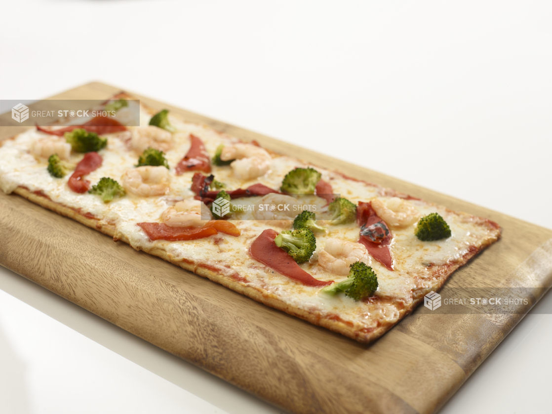 a slice of pizza sitting on top of a wooden cutting board