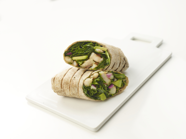 Salad wrap sandwich with shrimp on a white cutting board, white background