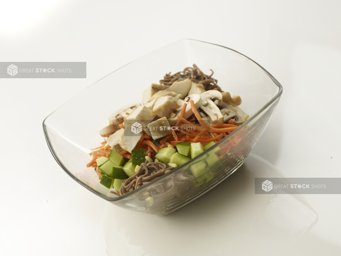 chopped chicken salad with soba noodles in a glass bowl