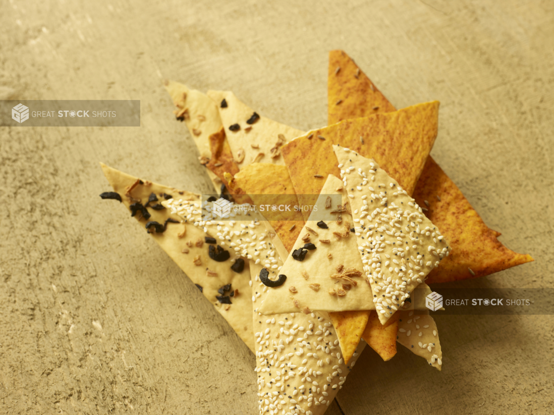 Overhead View of Assorted Artisanal Flatbread Crackers Piled in a Stack on an Untreated Wood Surface