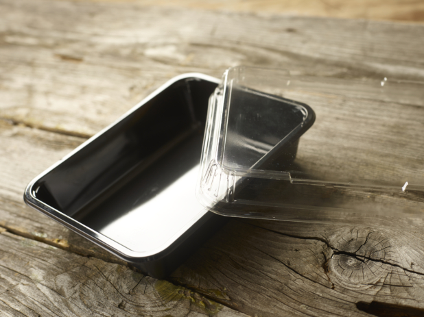 Rectangular Plastic Take-Out Container with Clear Lid and Black Base on Aged Wooden Table – Open Lid; Variation