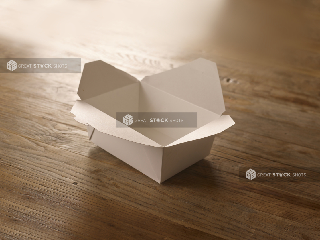 White Cardboard Take-Out Container, Open on a Rustic Wooden Surface in an Indoor Setting