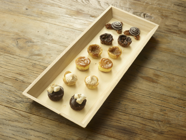 Assorted Mini Tarts and Cakes on a Narrow Rectangular Wood Tray on a Wooden Table - for Catering
