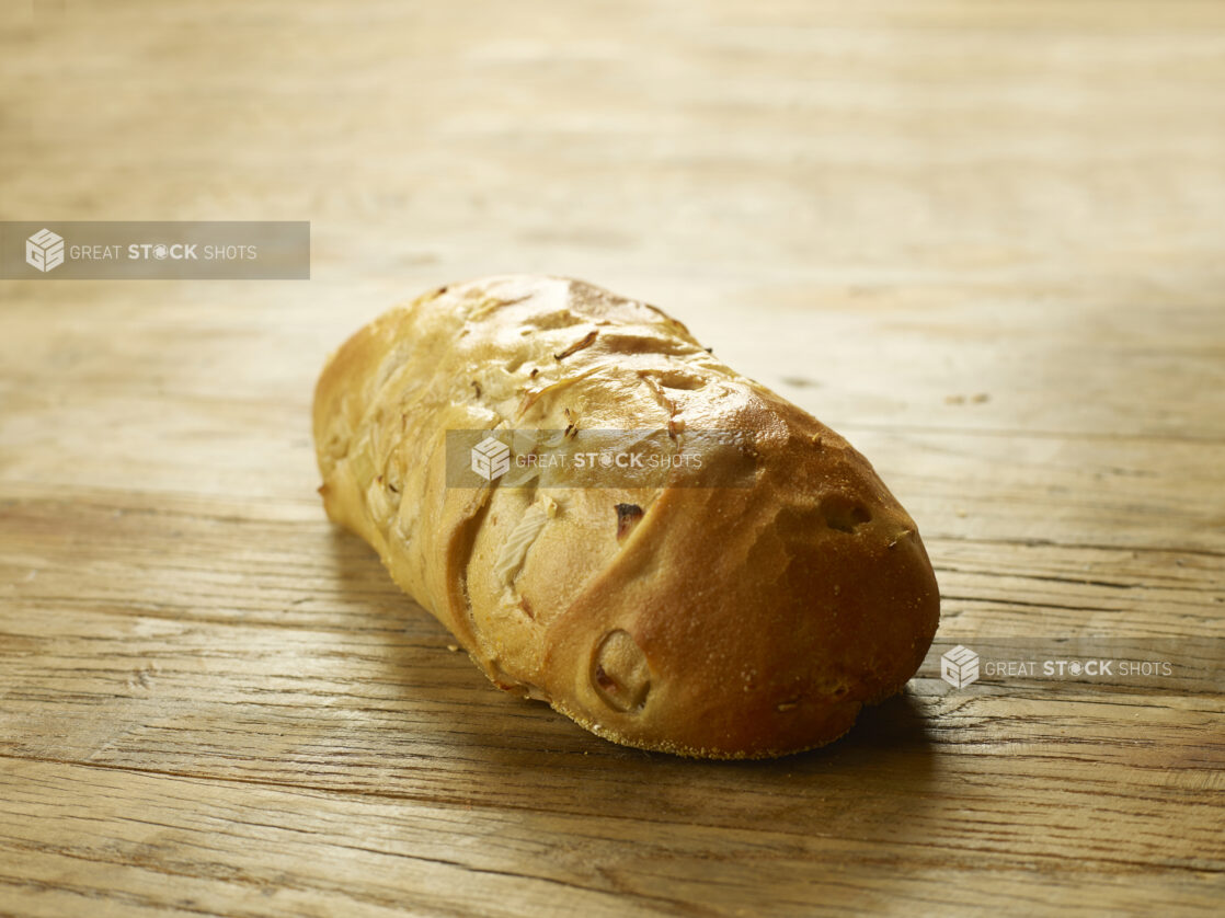 Whole onion bread, uncut, on a wooden board