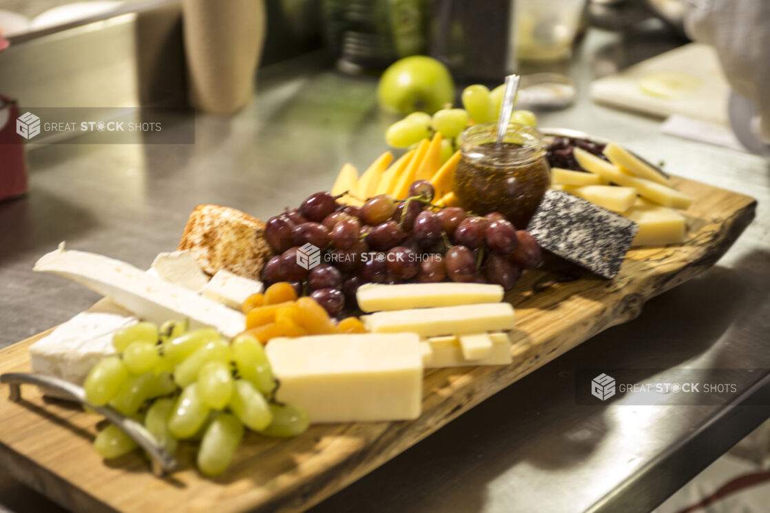 A Fruit and Cheese Platter Being Prepared in the Kitchen in a Restaurant Setting for Catering or a Party