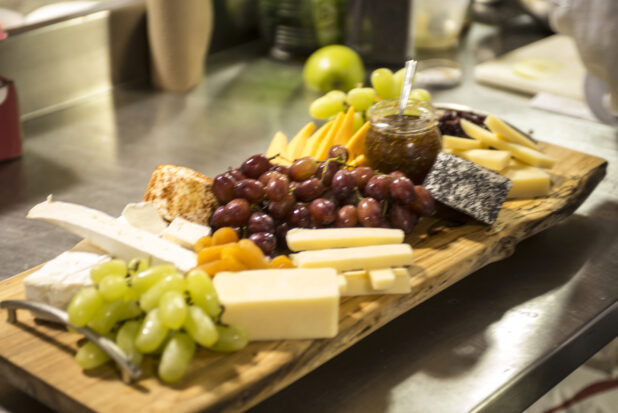 A Fruit and Cheese Platter Being Prepared in the Kitchen in a Restaurant Setting for Catering or a Party