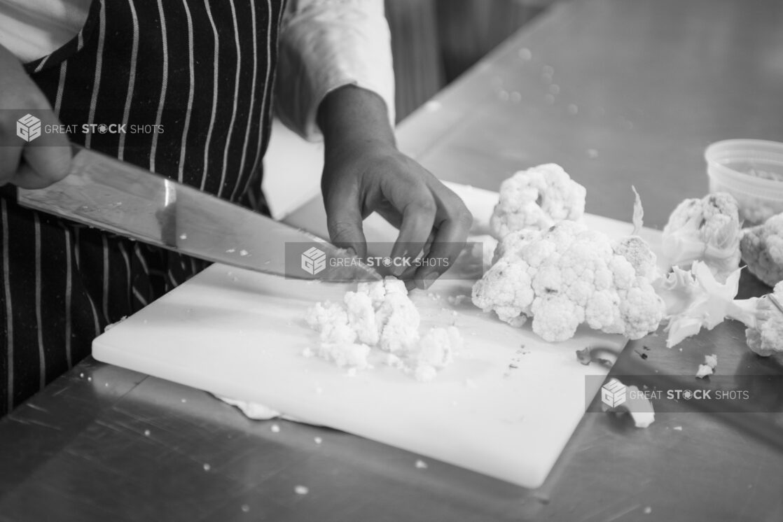 Black and white photo of chef prepping cauliflower