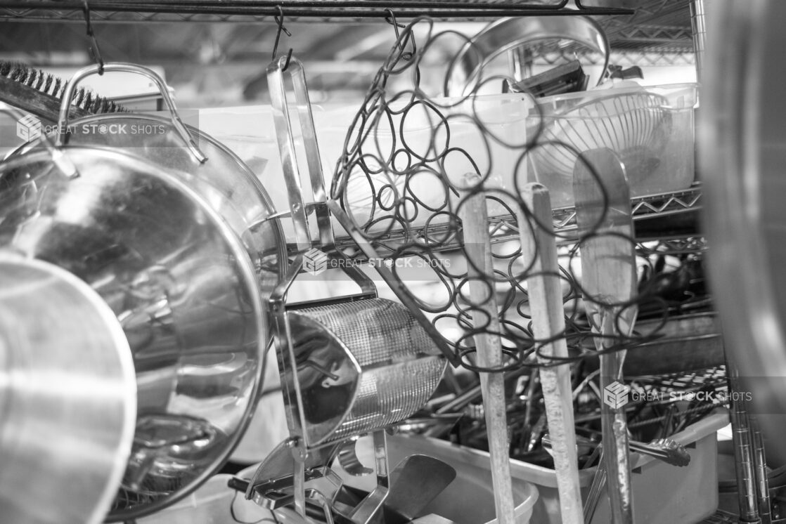 Black and white photo of various kitchen equipment in a restaurant setting