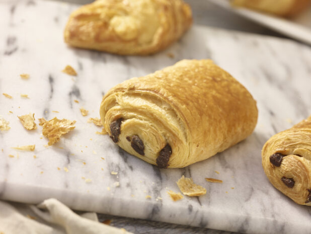 Mini chocolate danish in a close up view on a marble board