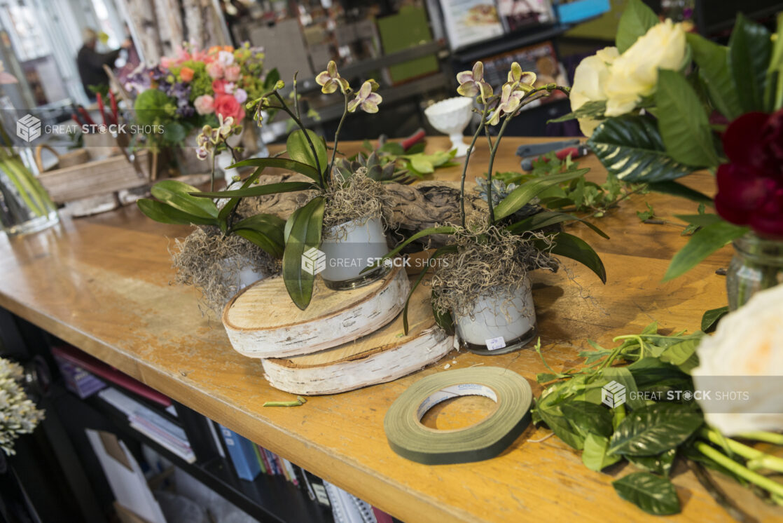 Floral designing on a wooden table, in a floral shop setting