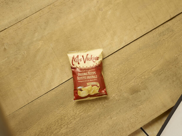 Snack size bag of Miss Vicki original chips overhead view on wooden background