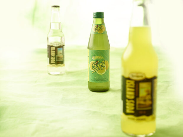 3 Caribbean sodas in glass bottles on lemon/lime green tablecloth
