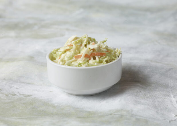 Creamy coleslaw/coleslaw in a white round bowl, side dish