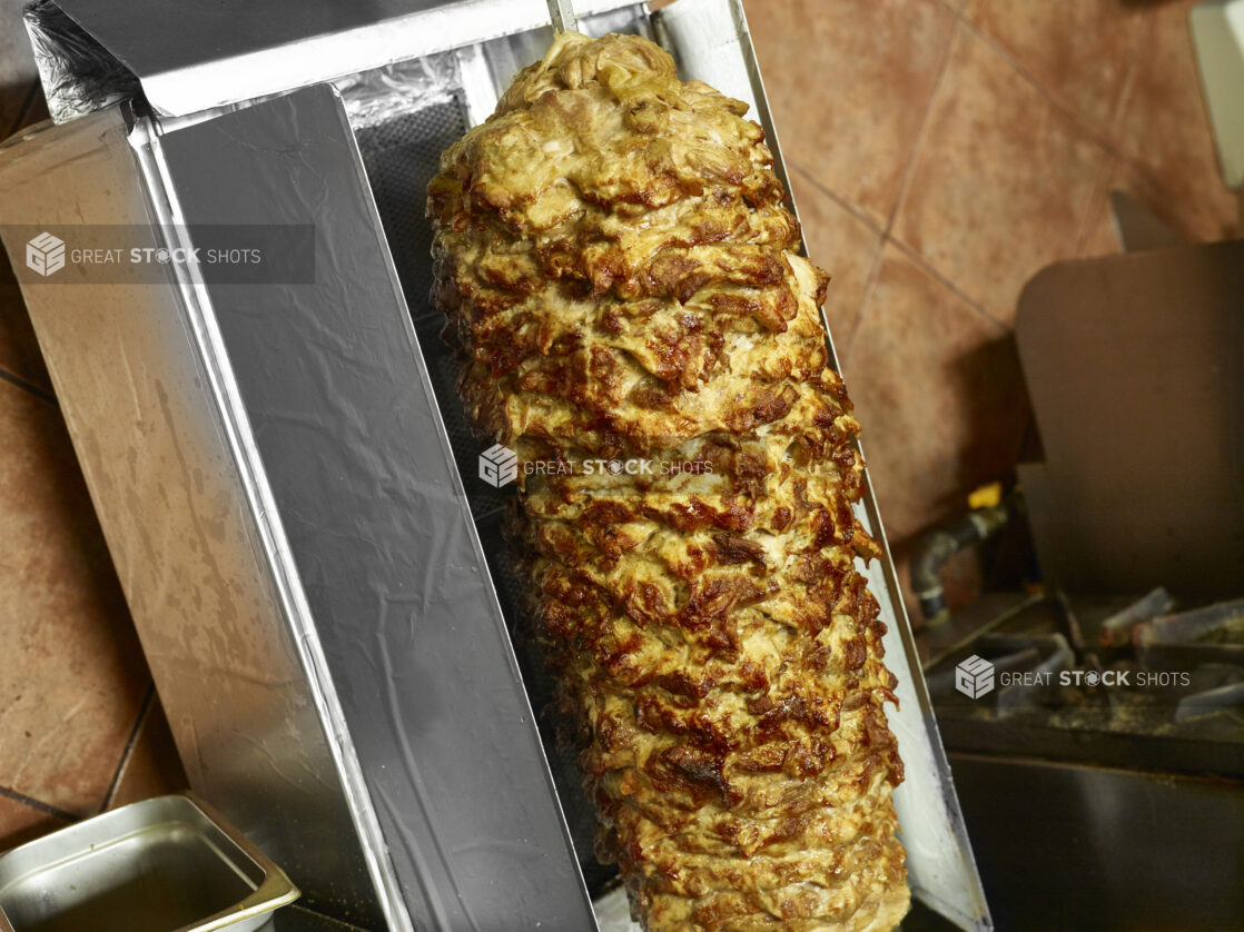 Cooked Chicken shawarma on a vertical broiler