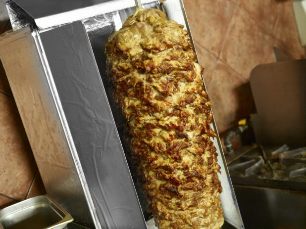 Cooked Chicken shawarma on a vertical broiler