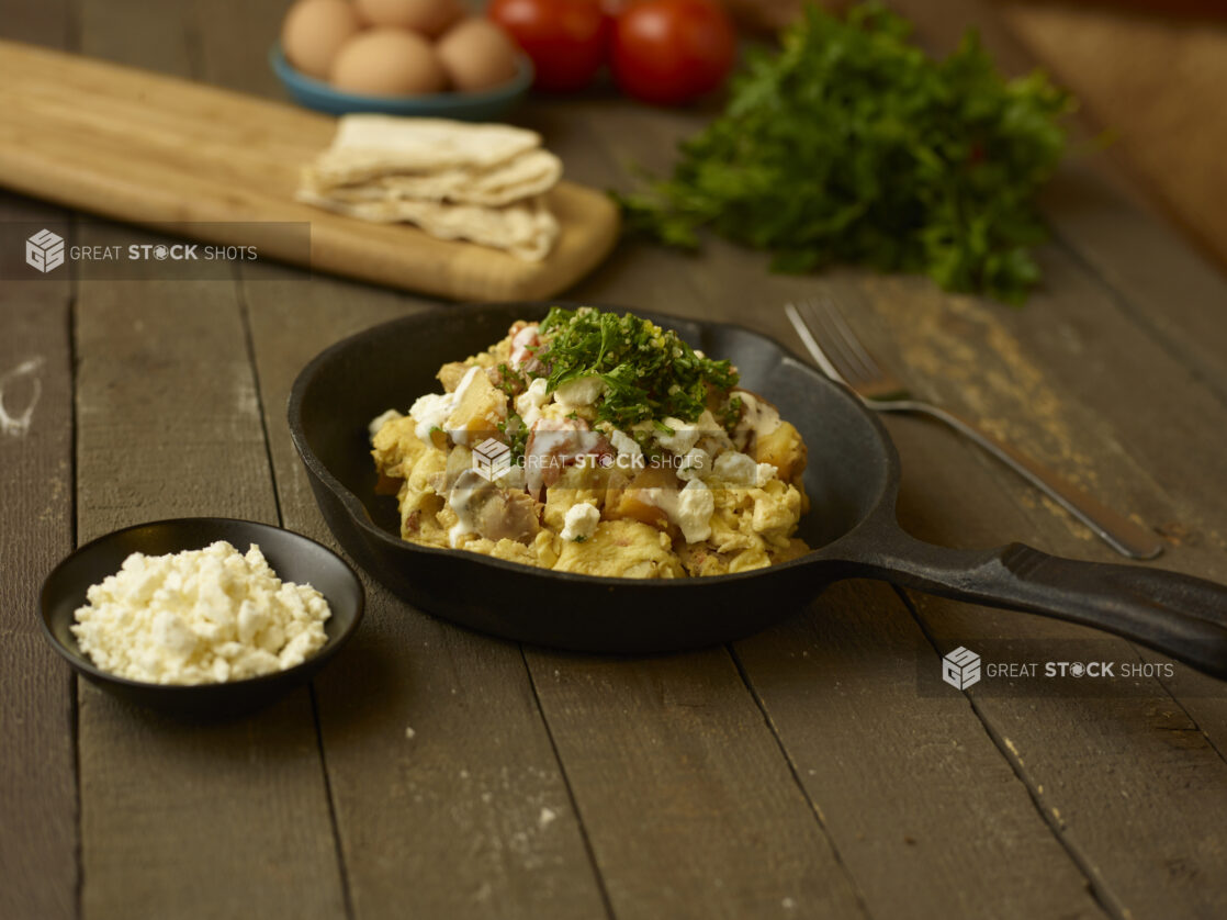 Chicken shawarma breakfast bowl in a skillet on a rustic table