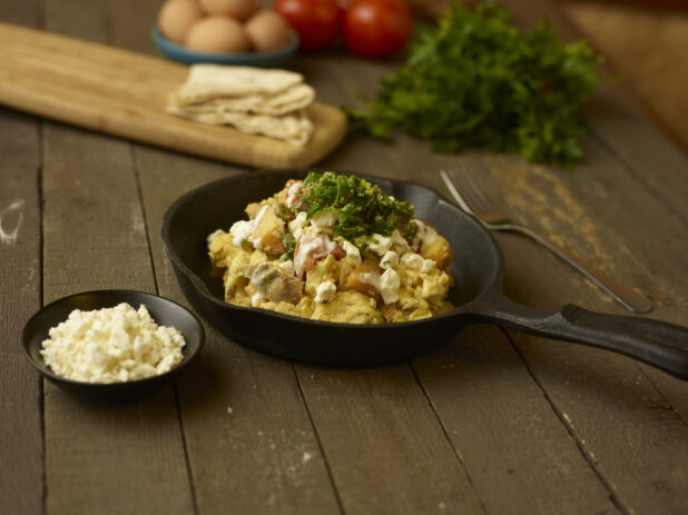 Chicken shawarma breakfast bowl in a skillet on a rustic table