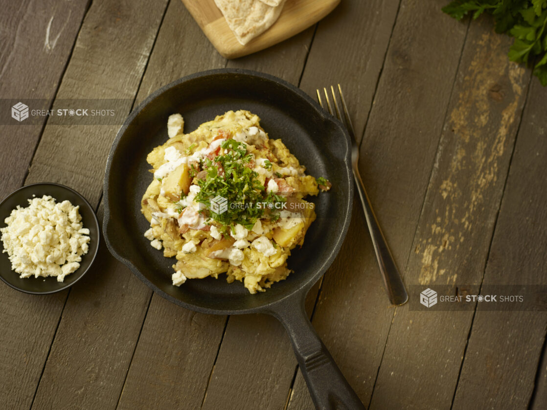 Chicken shawarma breakfast bowl in a skillet on a rustic table