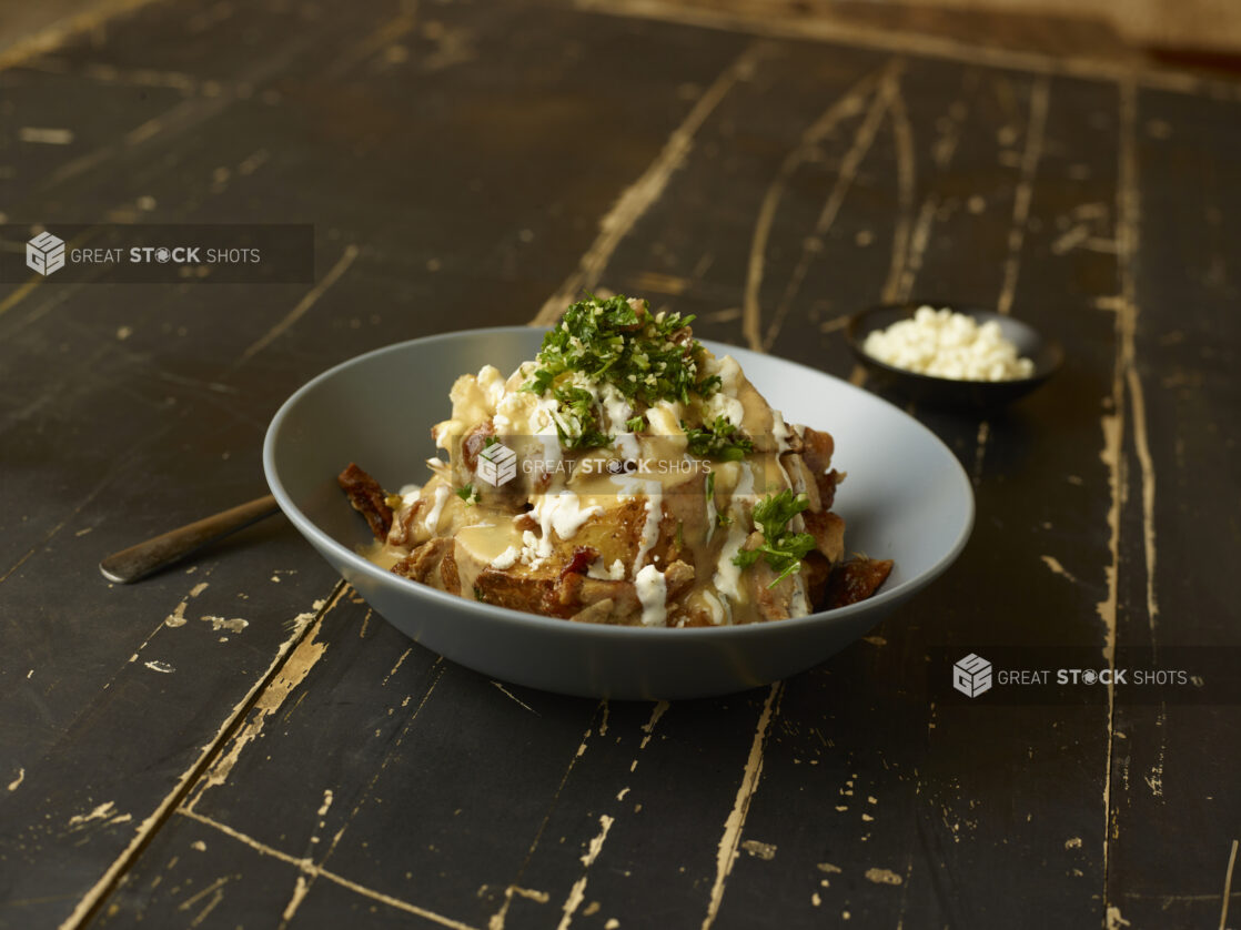 Middle Eastern potato bowl on a weathered black painter wood table, dark background