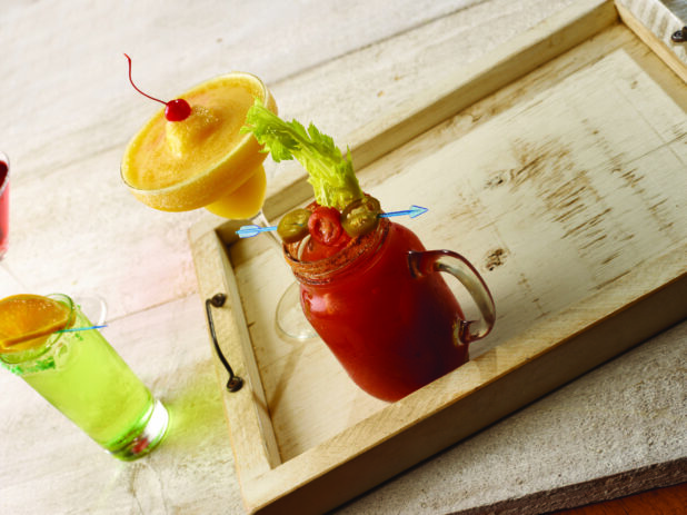 Bloody mary / caesar with tropical margarita and highball cocktail on a wooden tray