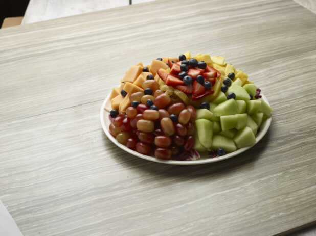 Large fruit platter, tray on a light wooden background