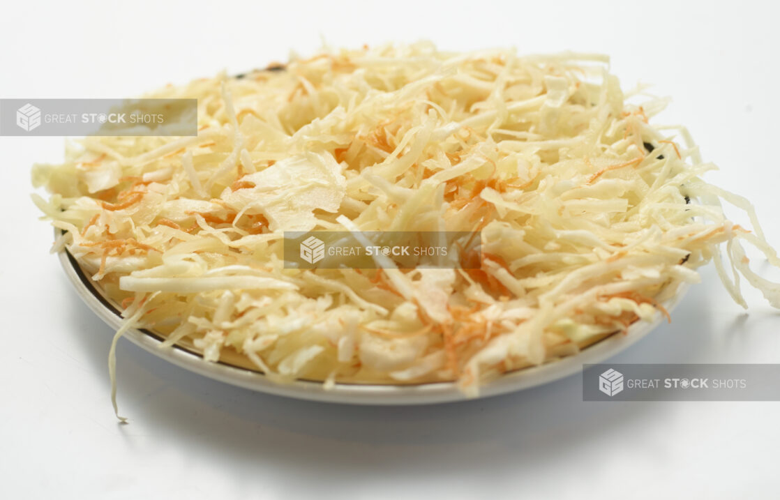 Plate of vinaigrette coleslaw on a white background