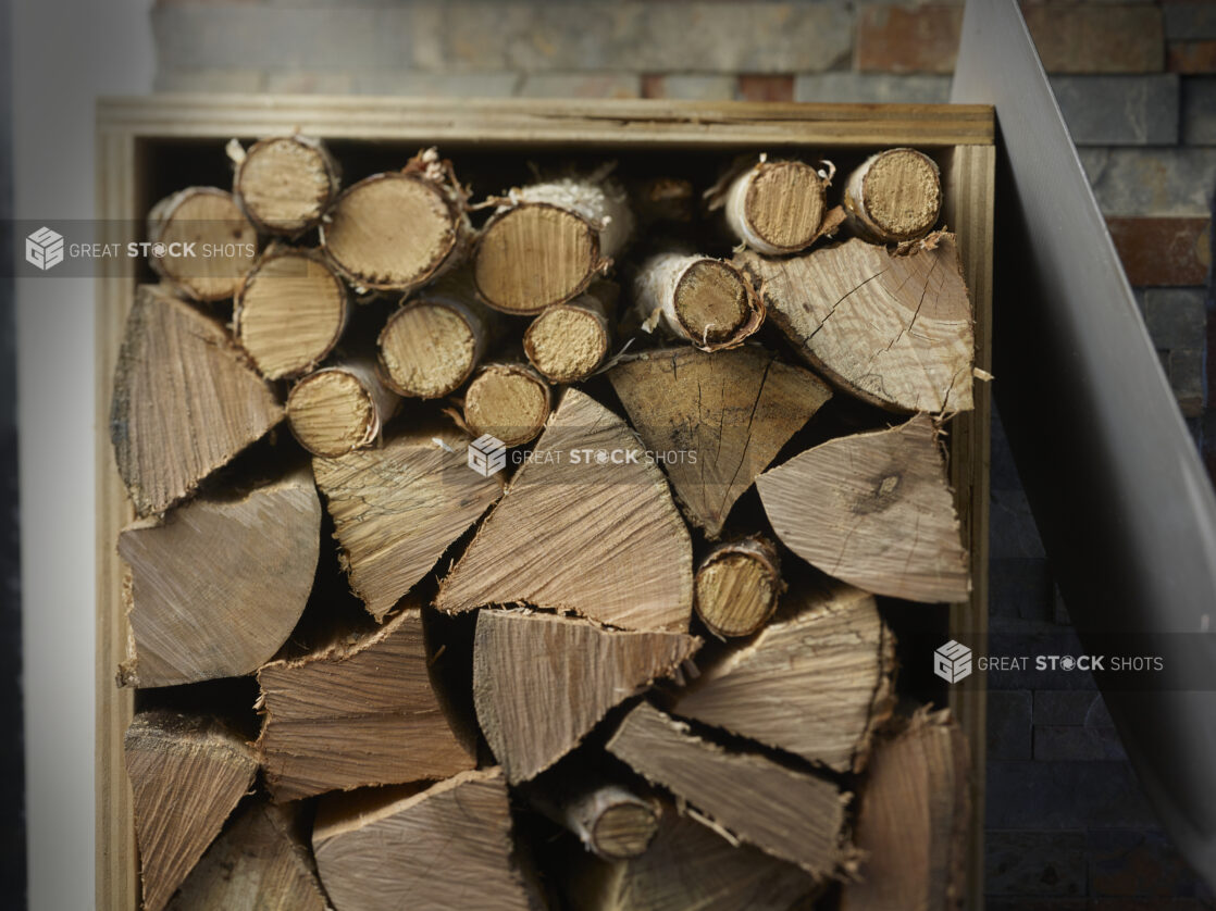 Stacks of wood in a wooden box shed