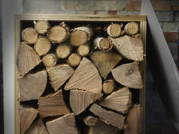 Stacks of wood in a wooden box shed