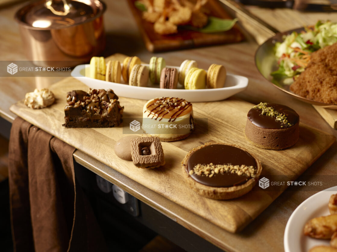 Selection of decadent desserts on a wooden board