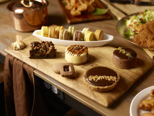 Selection of decadent desserts on a wooden board