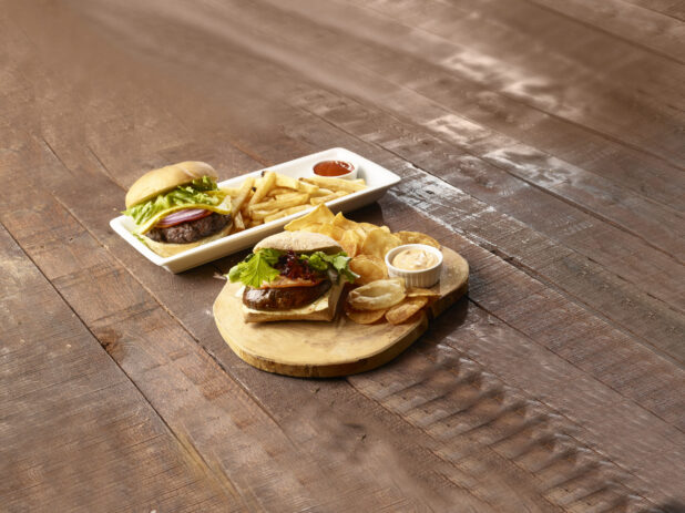 Hamburger and sandwich combos on a dark wooden background