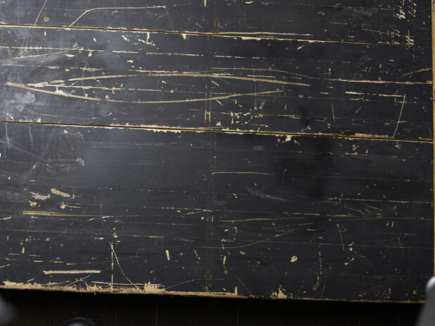 Overhead view of distressed black painted wooden boards