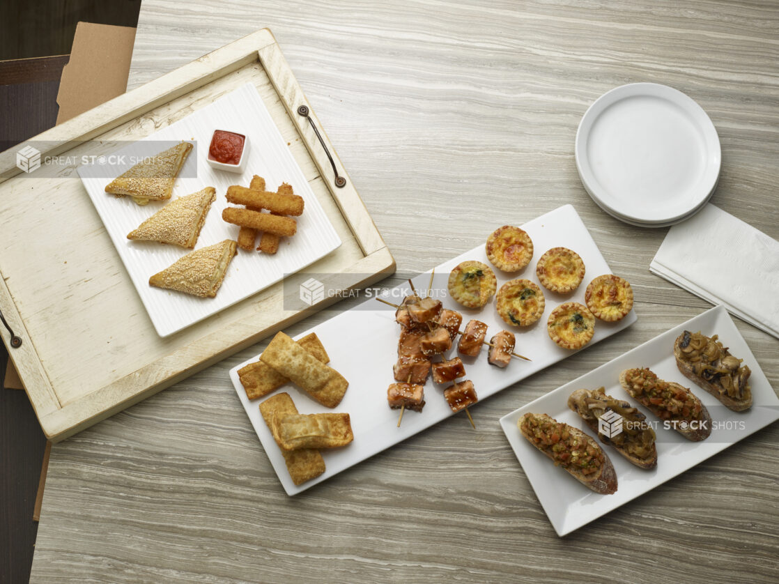 Various appetizers overhead on a wooden background