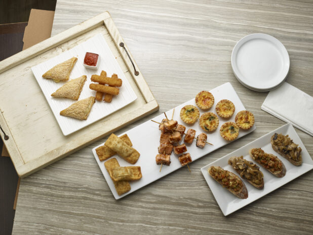 Various appetizers overhead on a wooden background