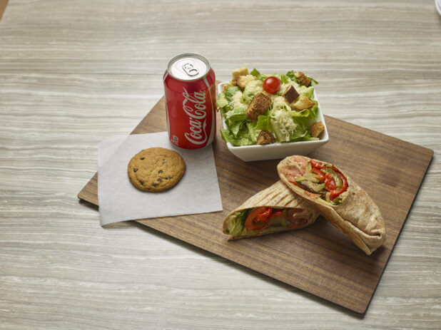 Grilled vegetable wrap with a side caesar salad, pop and chocolate chip cookie
