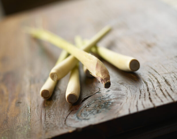 Fresh lemongrass on wooden background with partial focus