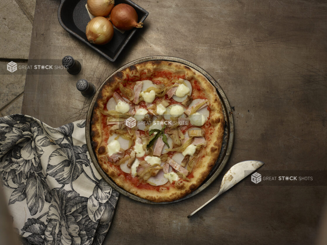 Whole pizza 4-topping pan pizza on dark background