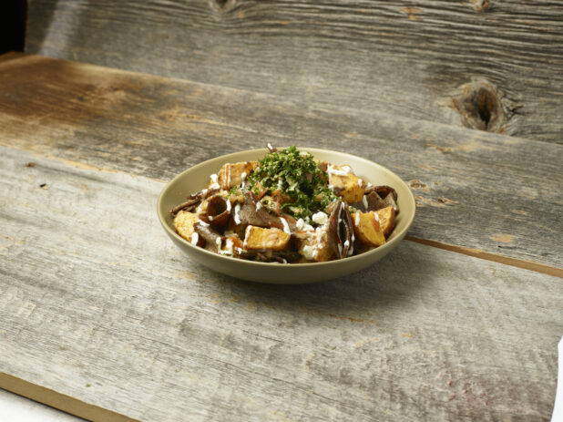 Gyros potato bowl on an aged wooden table and background