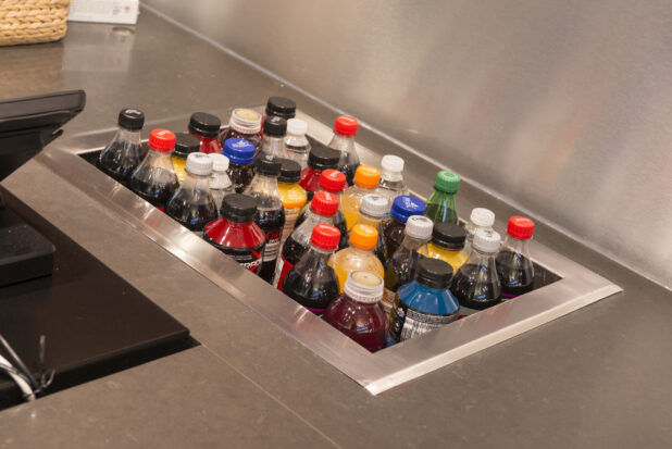 Various cold beverages in a built-in tub in a stainless steel counter