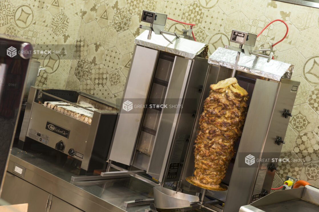 Restaurant equipment, 2 vertical broilers, chicken shawarma, flat top and indoor BBQ on a counter