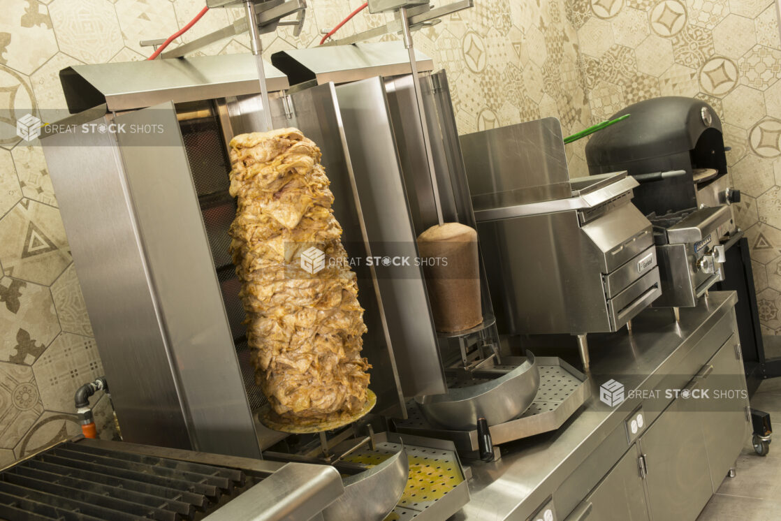 Restaurant kitchen with appliances, indoor grill, vertical broiler