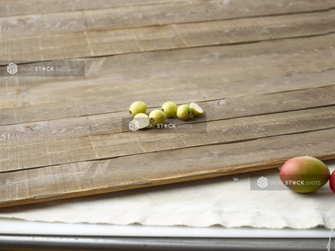 Guava on aged wooden planks with mangoes