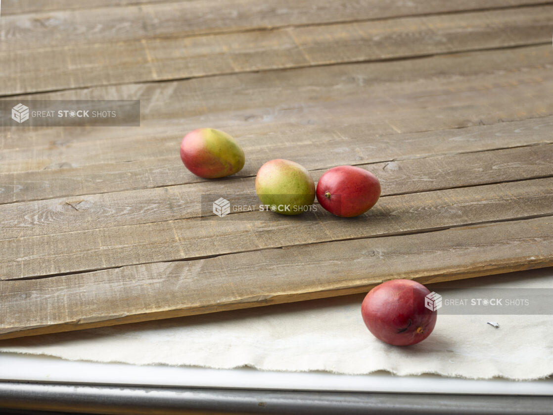 Fresh mangoes on aged wooden planks