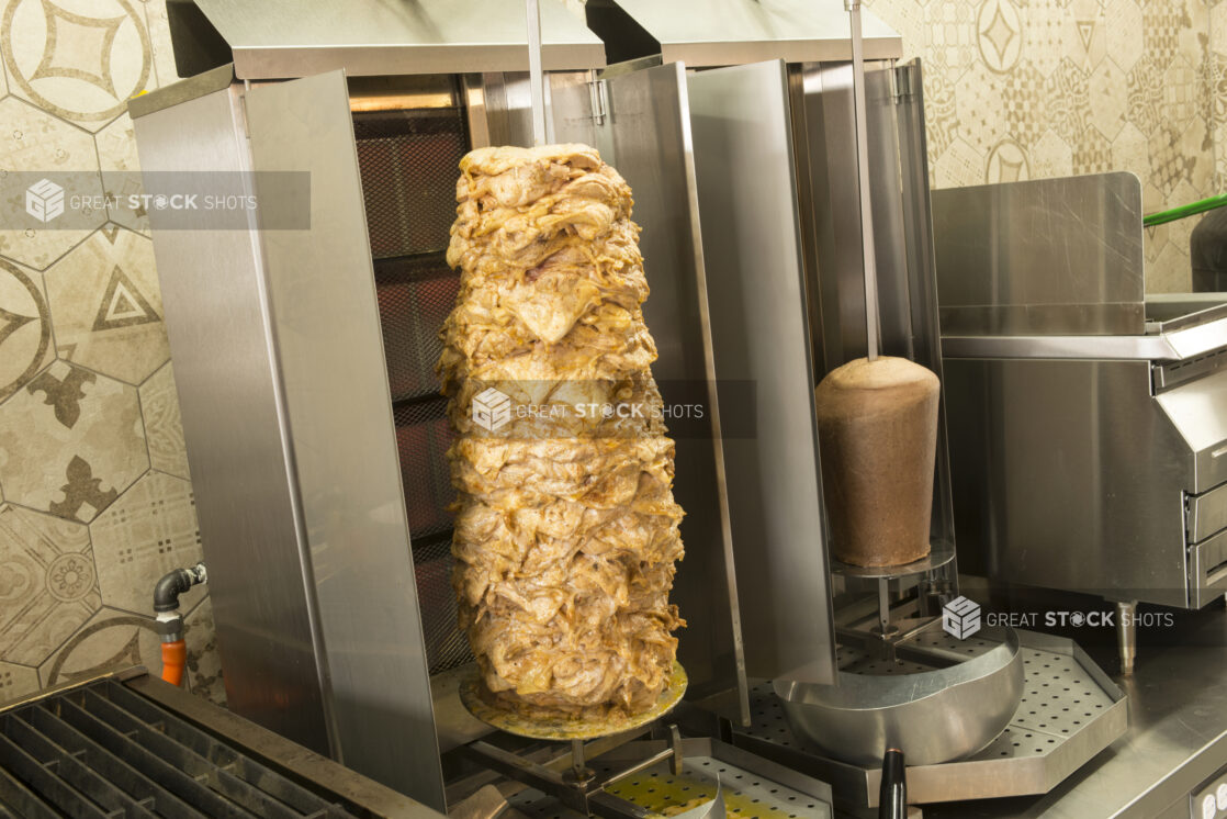 Vertical broilers with shawarma and gyros with a slight side view